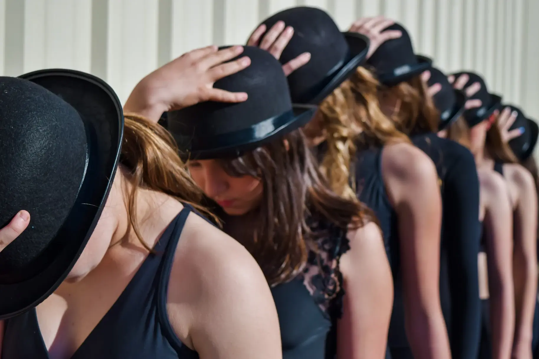 Studio 29 dancers in bowler hats lined up for a recital number
